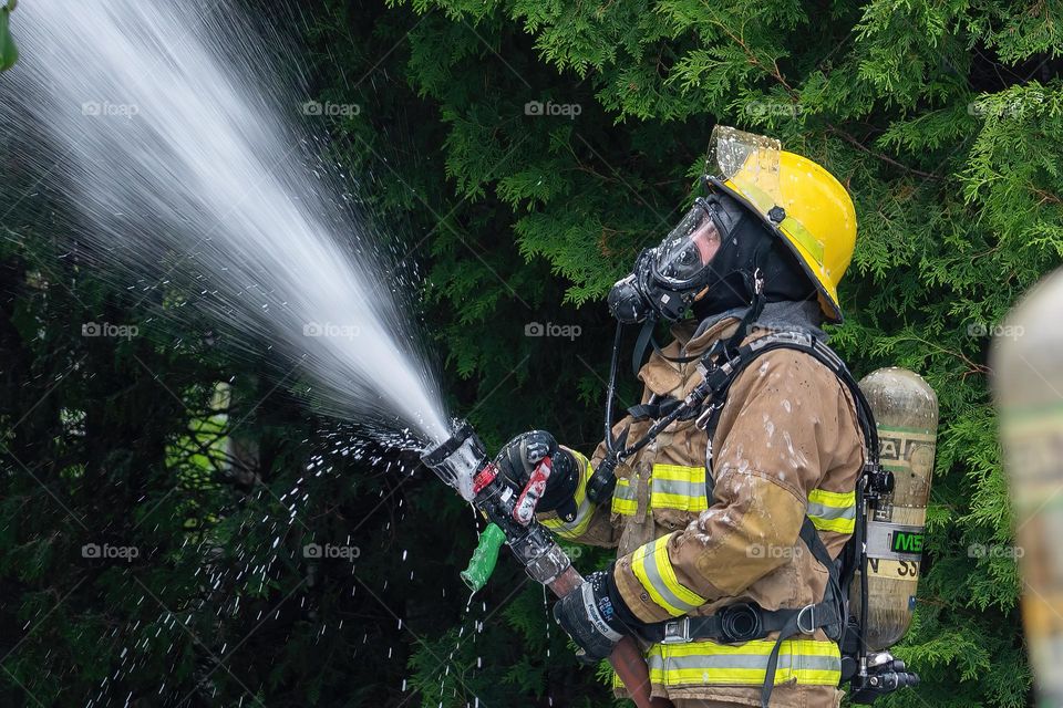 Firefighter fighting a house fire