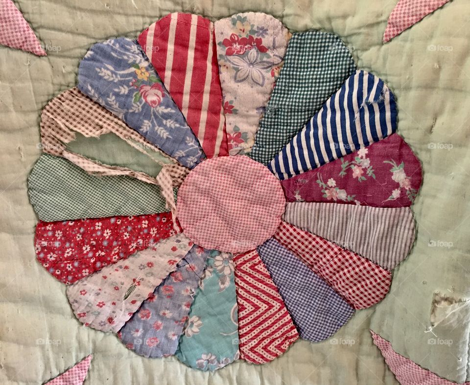 Worn and tattered old quilt
