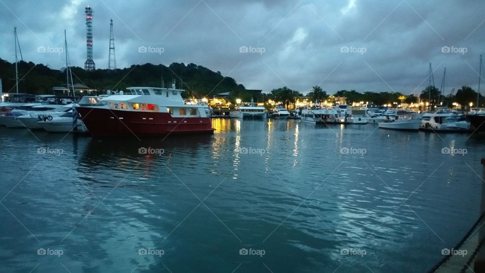 Sentosa Island sailboat Harbor, many beautiful moored sail yachts in the sea port, modern water transport, summertime vacation, luxury lifestyle and wealth concept.