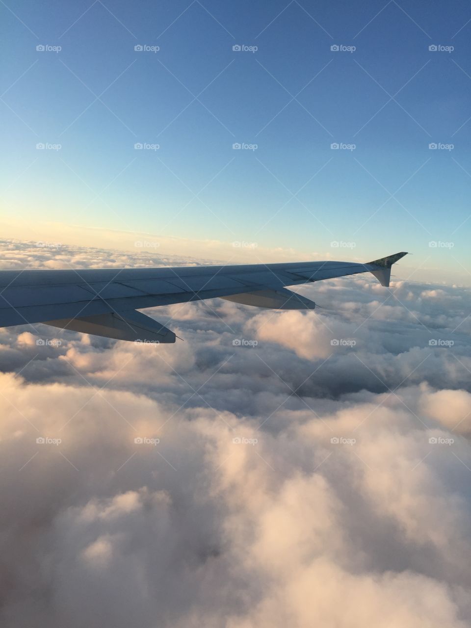 Airplane flying over clouds
