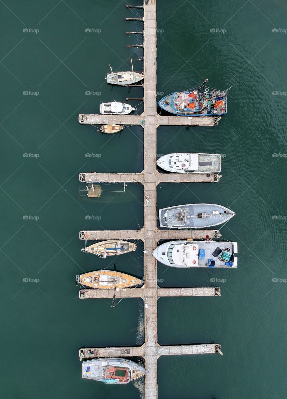 North Arm Fisherman’s wharf & marina aerial photo showing fishing boats and recreational craft and one sunken boat