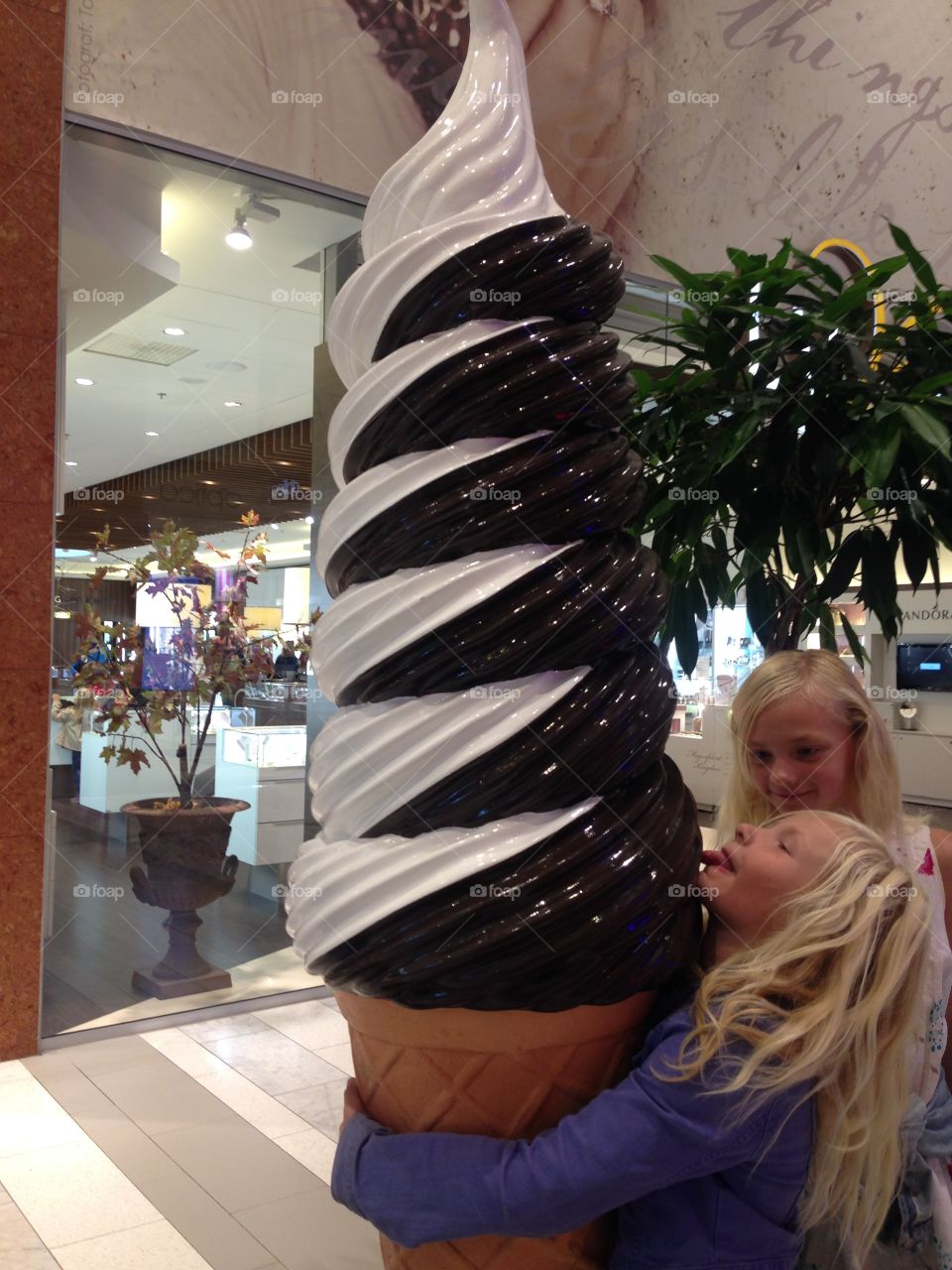 Girl standing with fake ice cream in restaurant