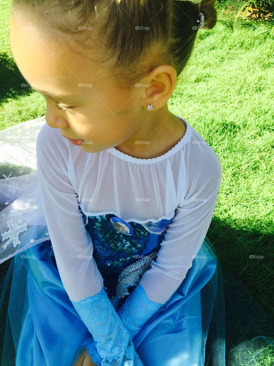 High angle view of a girl sitting on grass