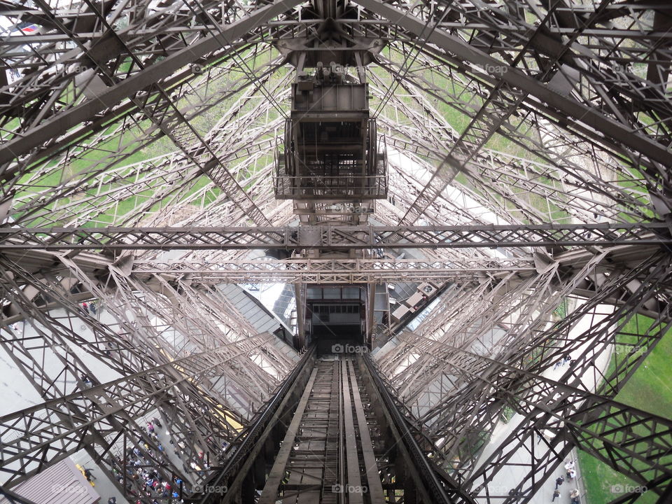 Staring down the Eiffel Tower lift on a sunny day in Paris. I love the geometry, engineering and architecture on display in this photo