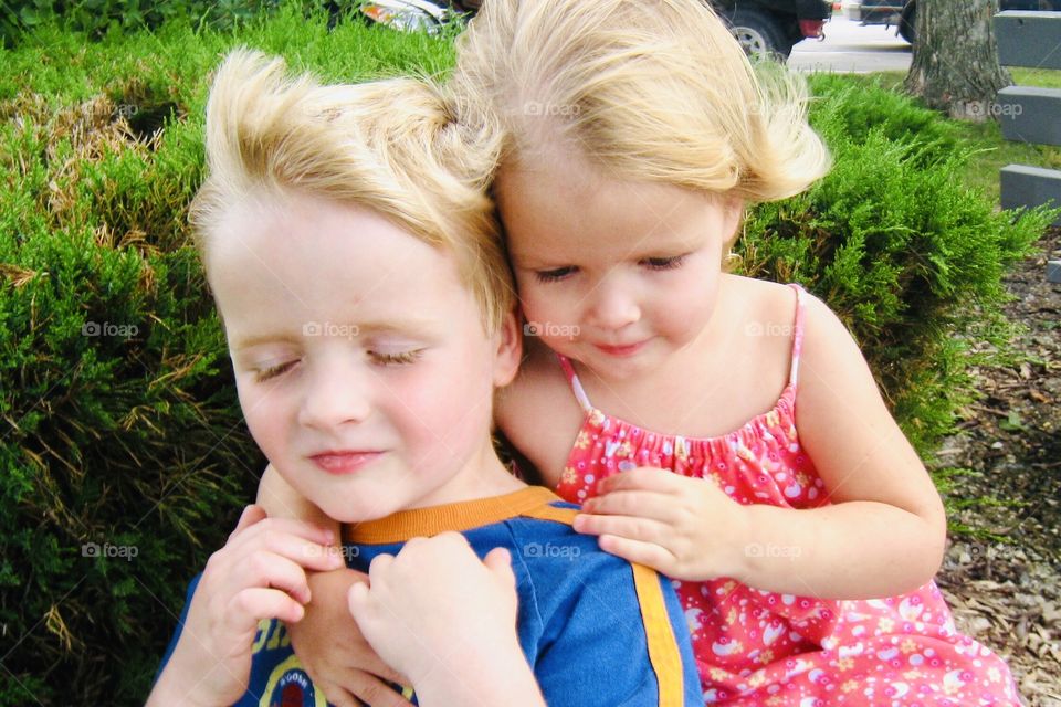 Gorgeous pretty photo of two young children brother and sister hugging each other!! 