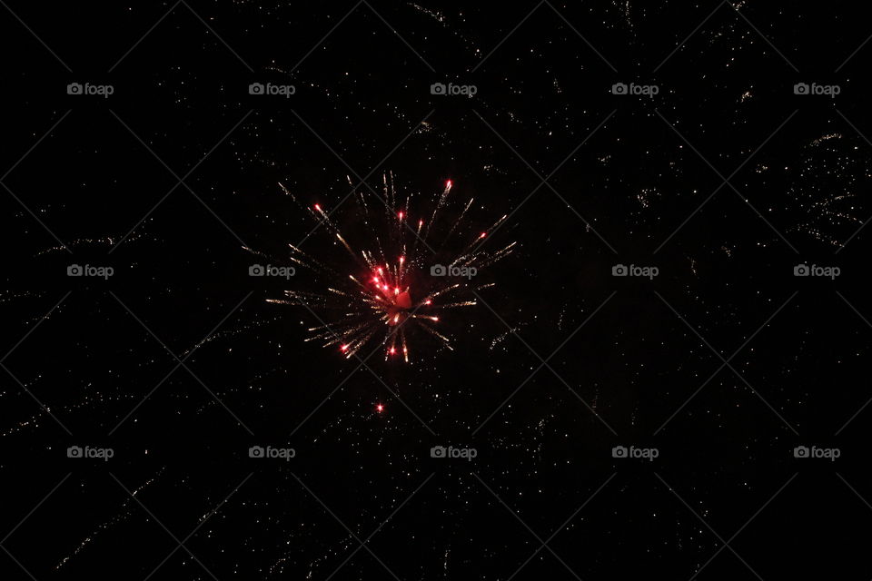 Fireworks explosion on a dark night, photo taken from below