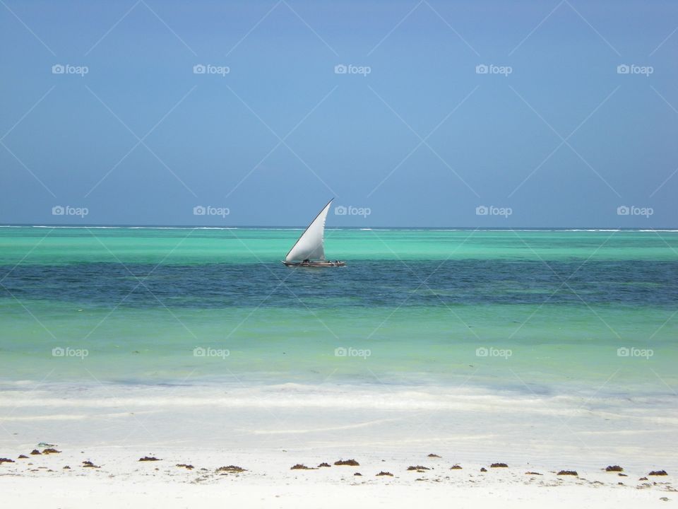 Tropical white beach and sail boat