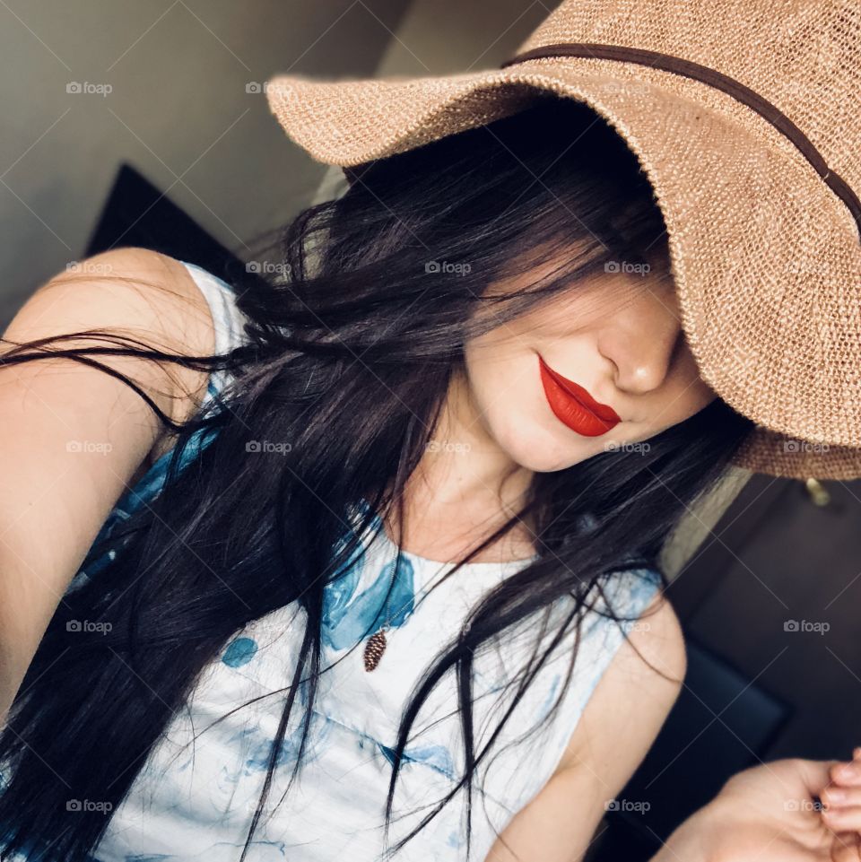 Brunette girl in a sun hat 