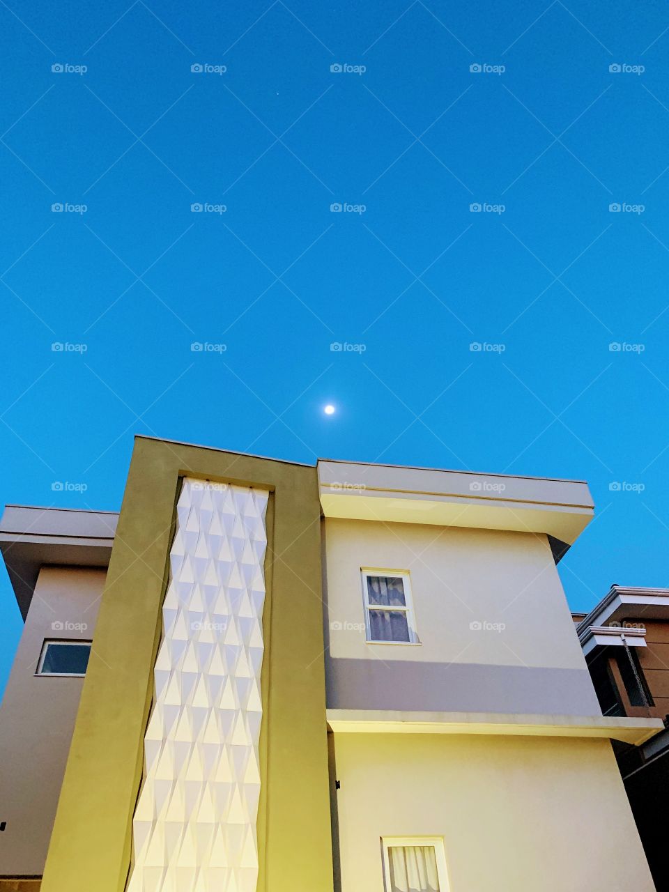 Facade of a house with blue sky and moon as frame