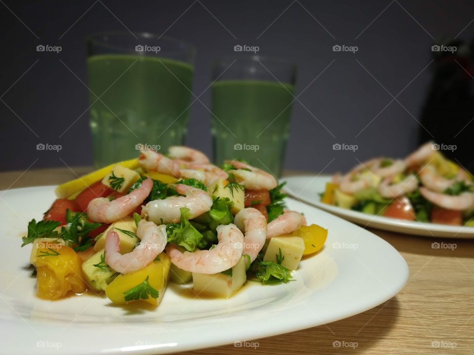 delicious homemade salad with shrimps, cheese, mango and herbs, dressed with citrus sauce