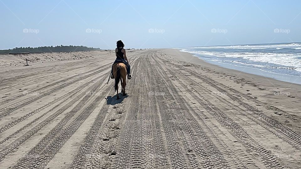 Horse girl on the beach