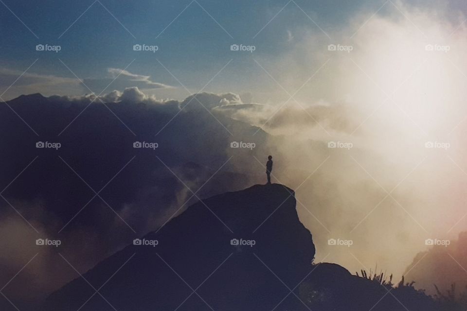 Young man at the top of the mountain