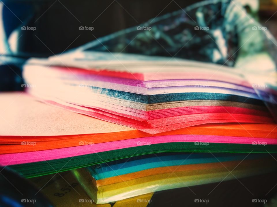 color love construction paper in every color of the rainbow wrapped in plastic stacked on top of itself