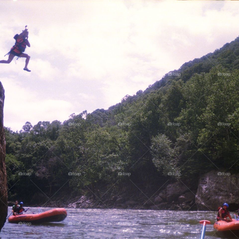 White water rafting cliff jump
