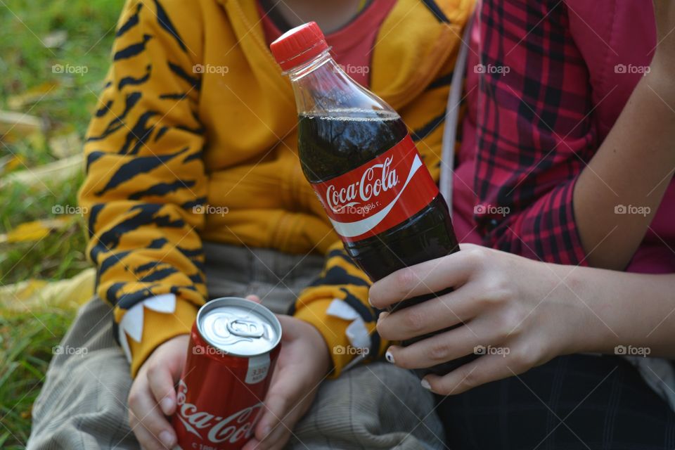 coca cola in the hands children picnic outdoor