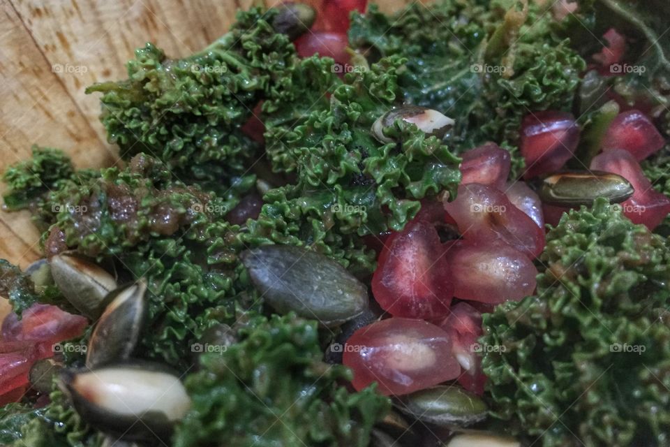 Close up of a kale and pomegranate salad