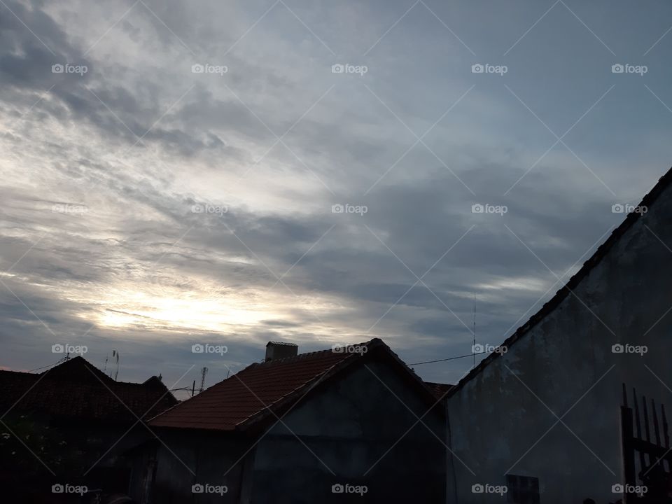 The morning sky in a gloomy day with roofs of some houses