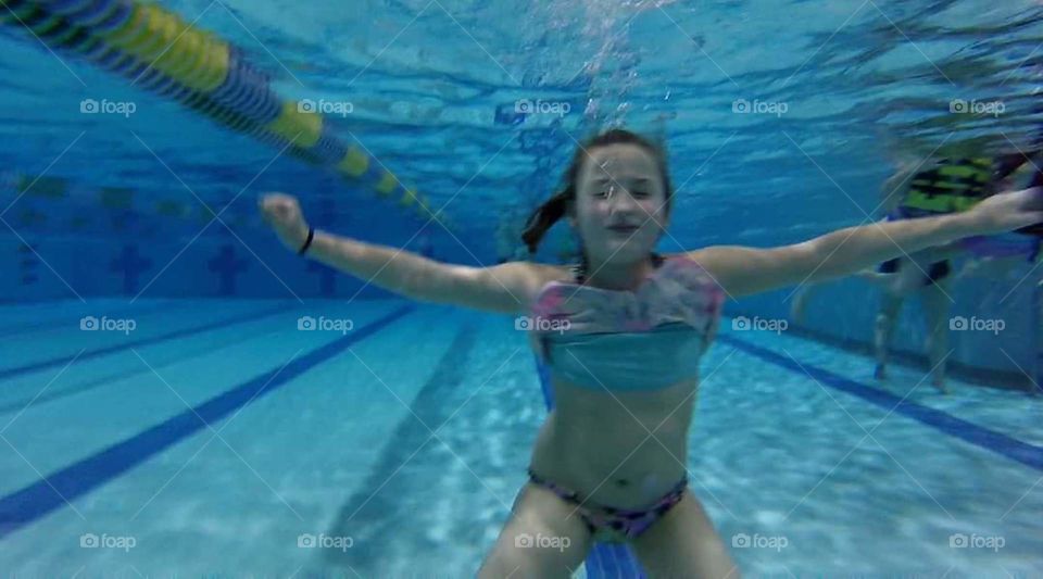 girl underwater, breathing bubbles