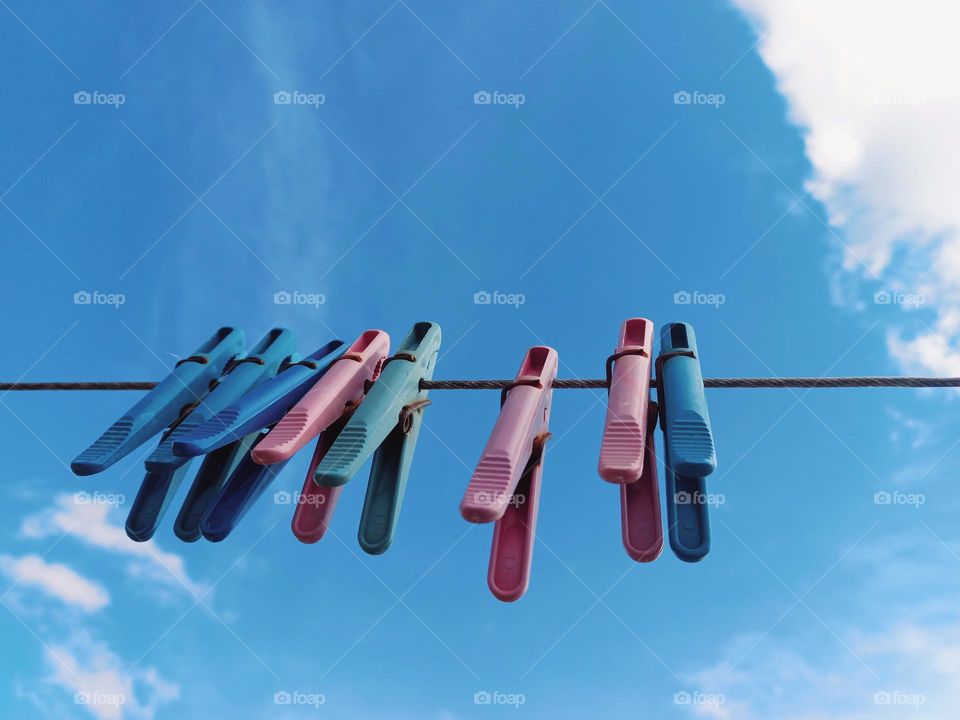 hanging clothespins against the blue sky.