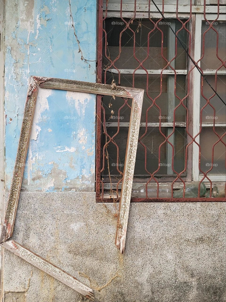 Mottled old house with barred windows and broken picture frames in rural military villages in Asia