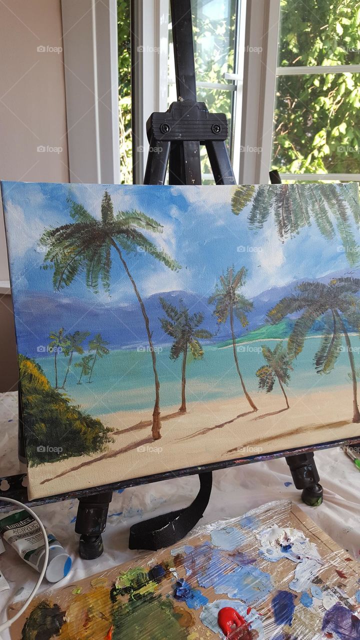 Painting in the process... Easel, canvas and paints for painting. 
A beautiful seascape is drawn. This is a drawing of a talented 10-year-old girl.