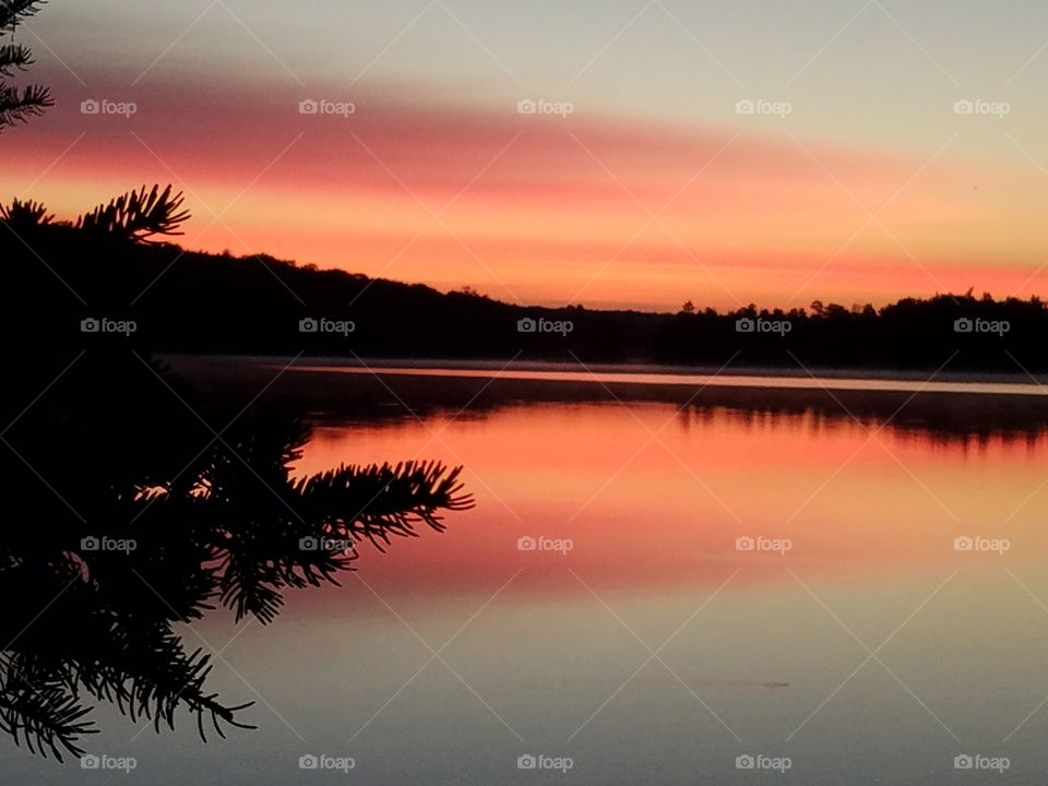Scenic view of calm lake at sunrise