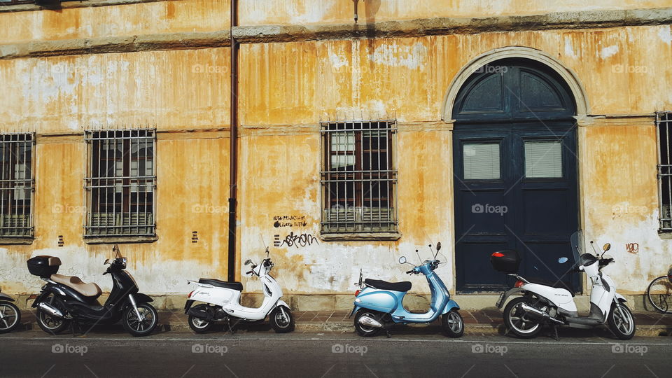 four bikes parked on the street of Italian city