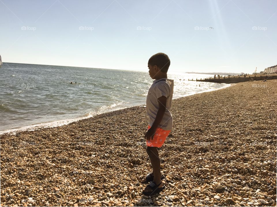 My son observing the view of the beach in Hastings.