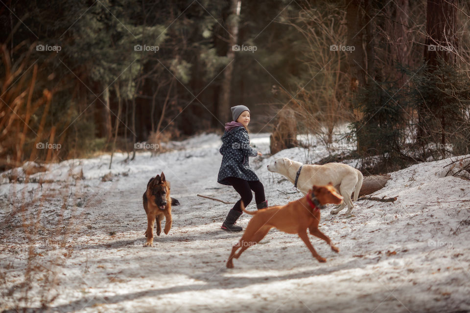 Girl walking with Dogs in a spring forest 