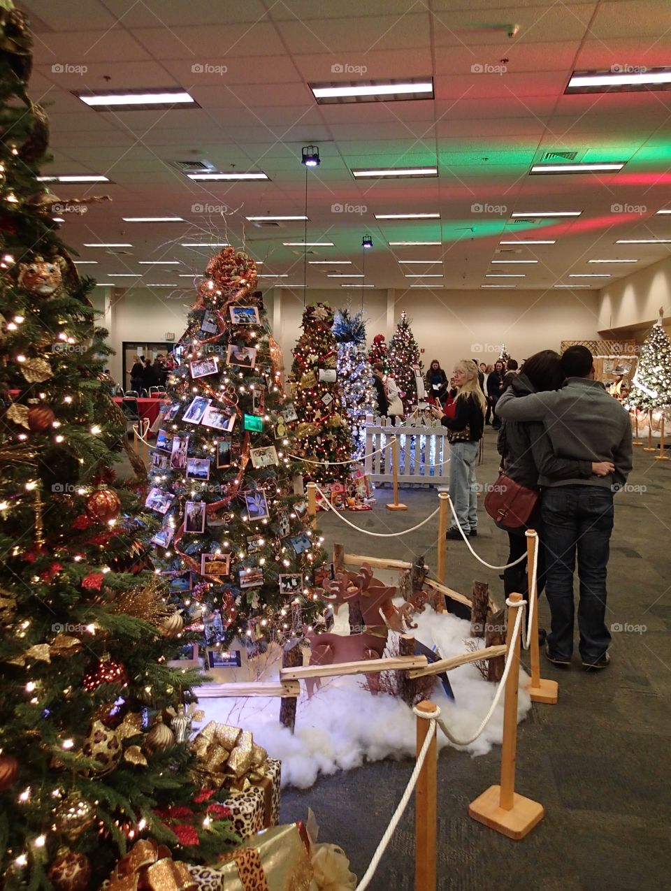 People enjoying some of the beautifully decorated Christmas trees at the annual Central Oregon Festival of Trees fundraising event during the holiday season. 