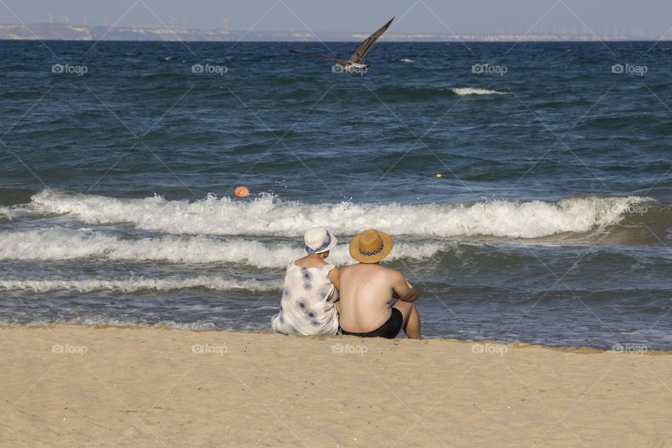 Back view of couple on the beach 