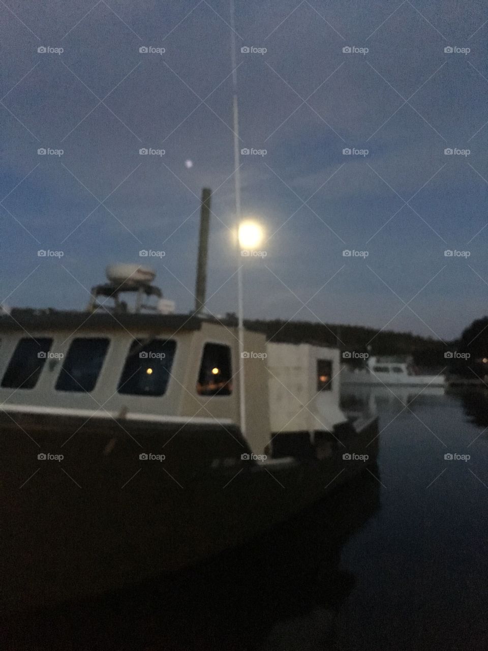 Northeast harbor Maine fishing boat with moon