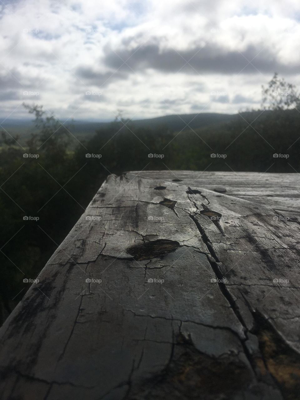 Bench with a view of mountains on a cloudy day