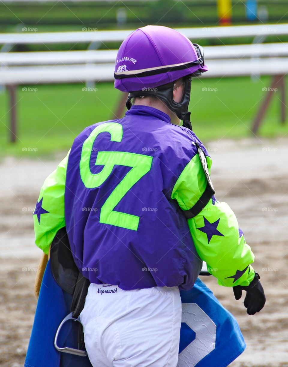 Gz.  Female jockey Rosie Napravnik wearing my purple and lime silks with the Gz letters on her back. 
Zazzle.com/Fleetphoto 