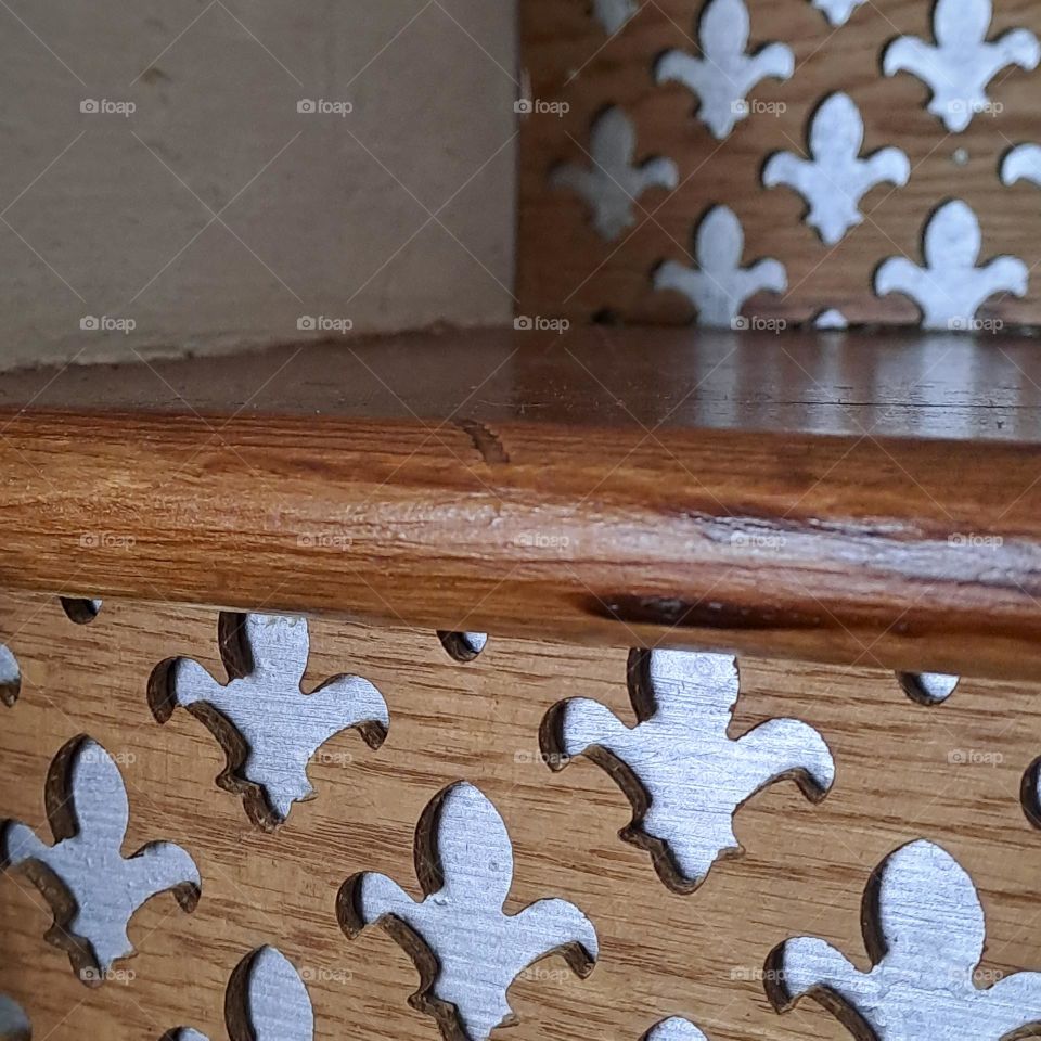 fleur de lye pattern on wooden stairs. grey shiny