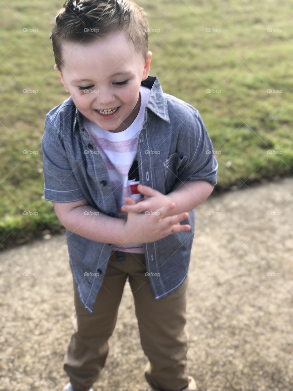 Happy boy playing outside in the sunshine 