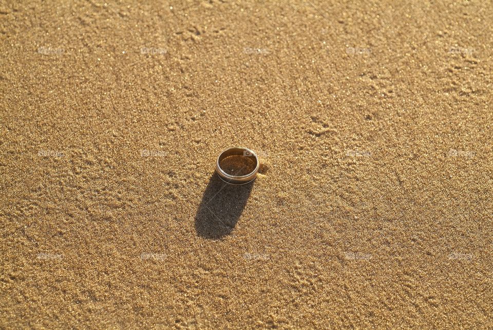 A wedding band in the sand.