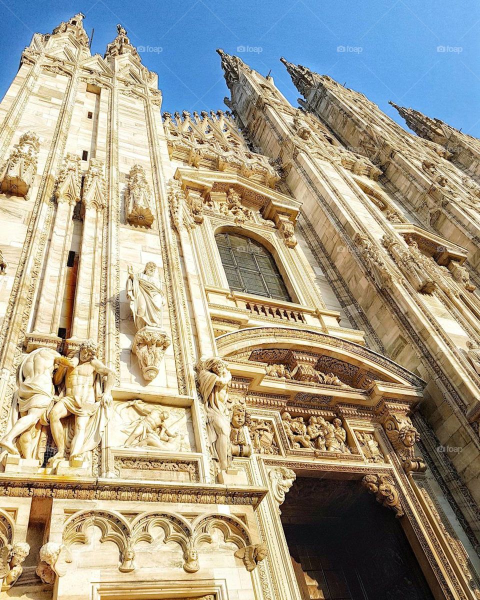 The Duomo of Milano is located on a sacred territory, which initially hosted the Pagan temple of Minerva. 
It holds the record for having more statues on their Gothic facade than in any other building in the world. There are 3,400 statues, 135 gargoyle and 700 figures that decorate the entire Duomo!