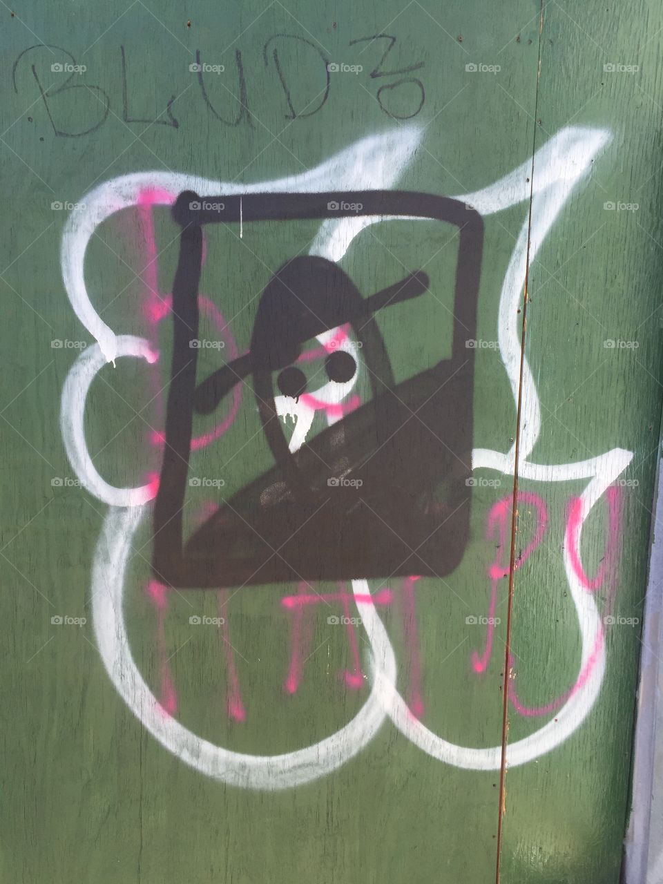 Graffiti sprayed on a construction citing of a depicted bandit or pirate . Bloods is also sprayed up top so it may indicate gang activity . Urban technique was used to make it look like a quick draft .  Great quick style. 