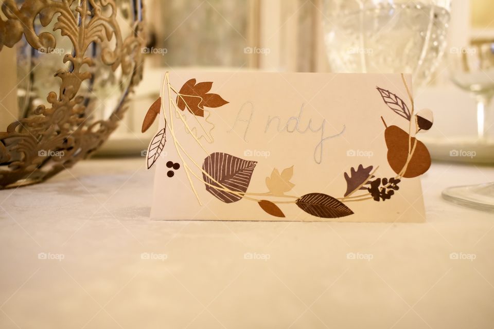 Place card on dinner table set for Thanksgiving holiday feast 