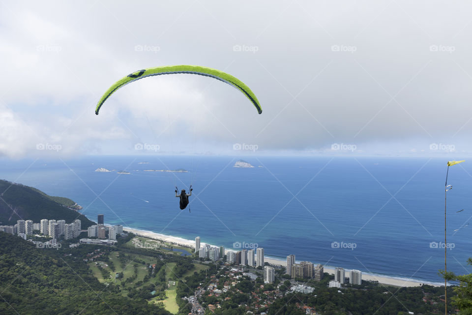 Paraglider flying over Sao Conrrado in Rio de Janeiro Brazil.