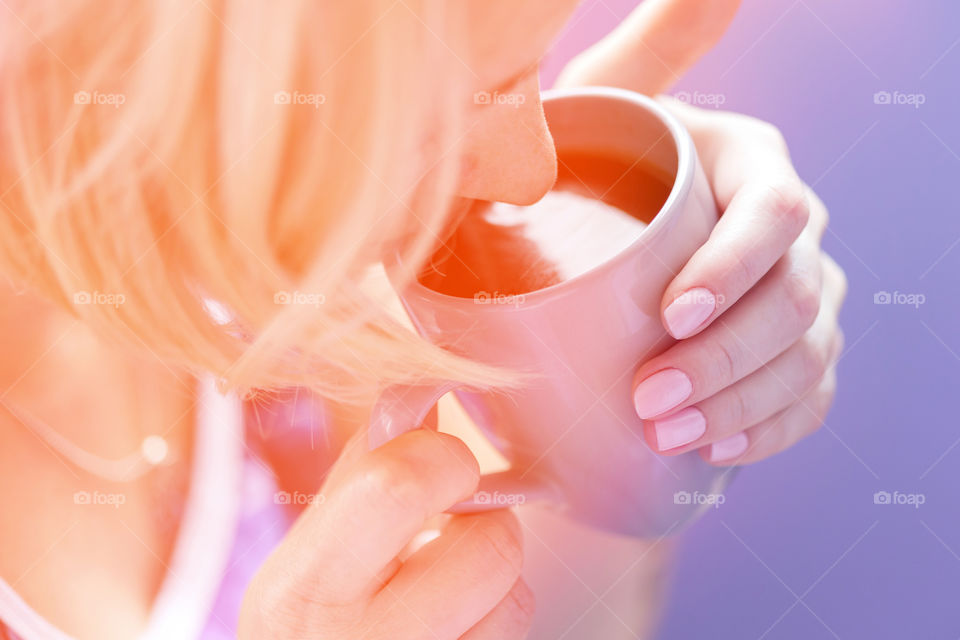 Young woman enjoying cup of coffee in the morning