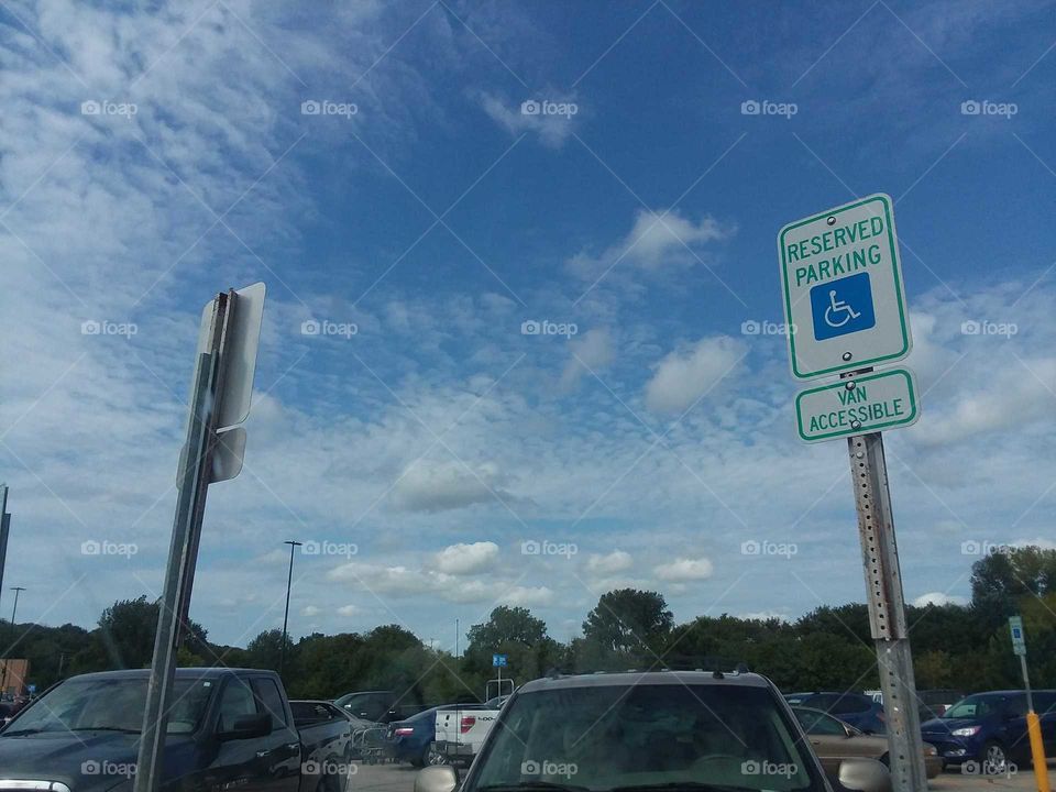lot sign clouds white blue sky