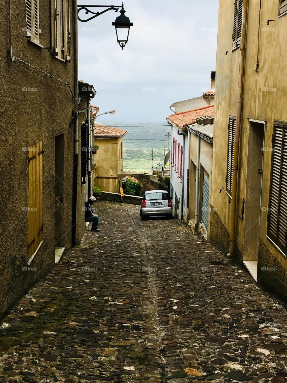An old narrow Italian street with lantern