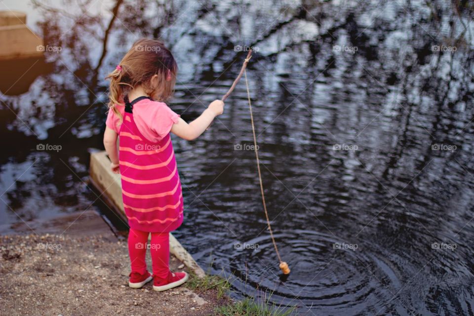 Kid Fishing morning springtime. Little girl enjoying the morning spring time fishing