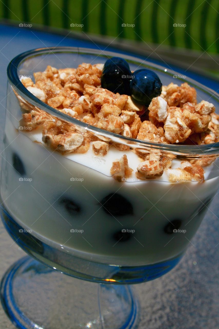 Morning Yogurt . Vanilla yogurt with blueberries and granola. 