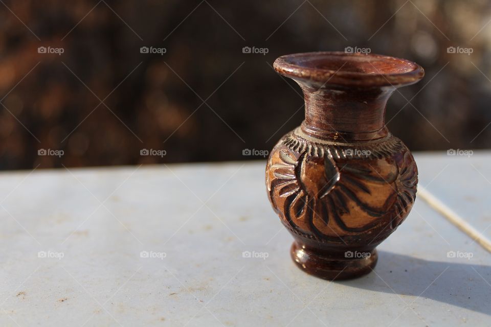 clay miniature vase with flower patterns