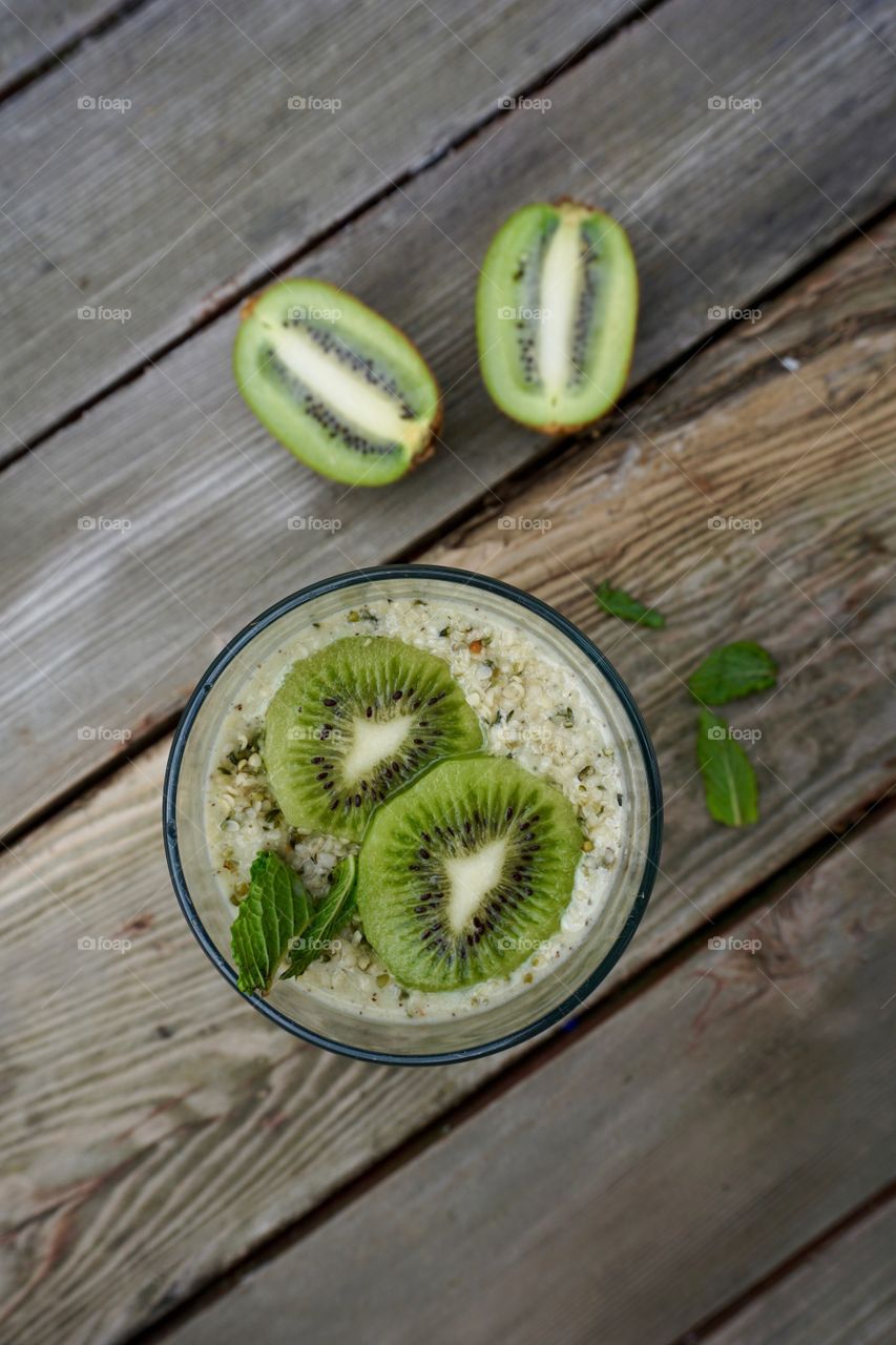 Overhead view kiwi smoothie on wooden table