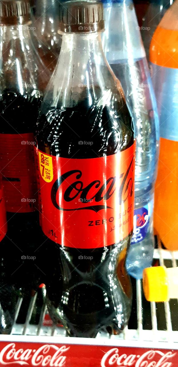 A classic Coca-Cola bottle with a fizzy red liquid and the iconic white logo, photographed in Casablanca, Morocco, on January 1, 2025.