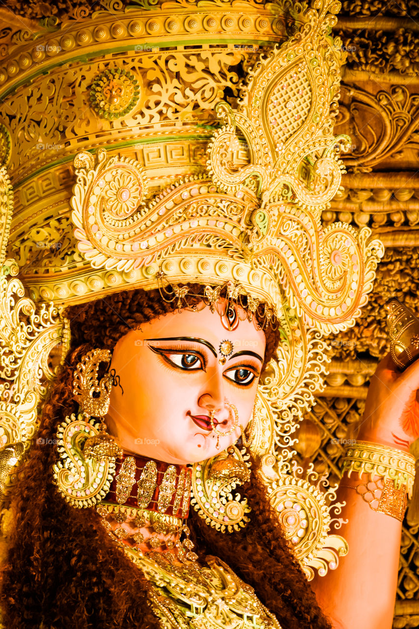Chandannagar, West Bengal, India - November 16, 2018: Portrait of Hindu Goddess Jagadhatri Idol during Jagadhatri Puja celebration. Close up. Very well decorated goddess idol with heavy ornaments.